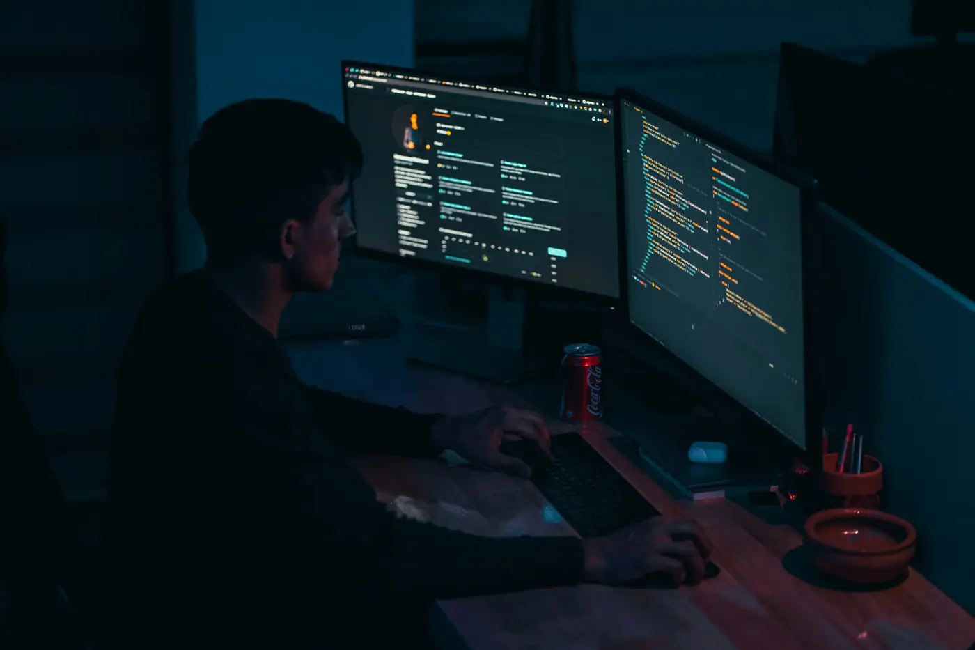 Developer working at a two-monitor desk